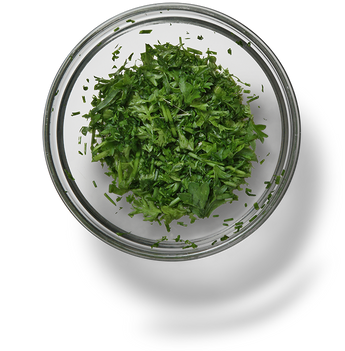 freshly chopped herbs in a glass bowl